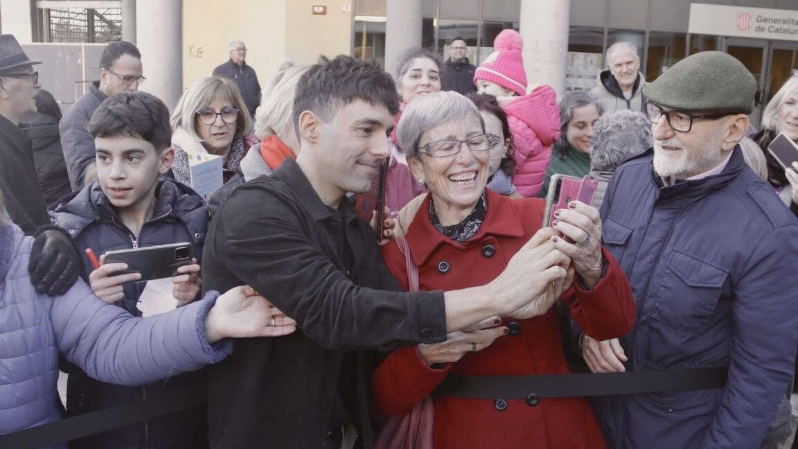 Personas multigeneracionales sonrientes tomando un selfie en el Mercadillo Navideño de Badia del Vallès