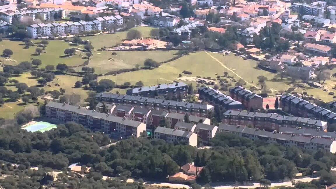 Vista aérea de edificios residenciales y zonas verdes que muestran el entorno del Mercado Ecológico de Buitrago del Lozoya
